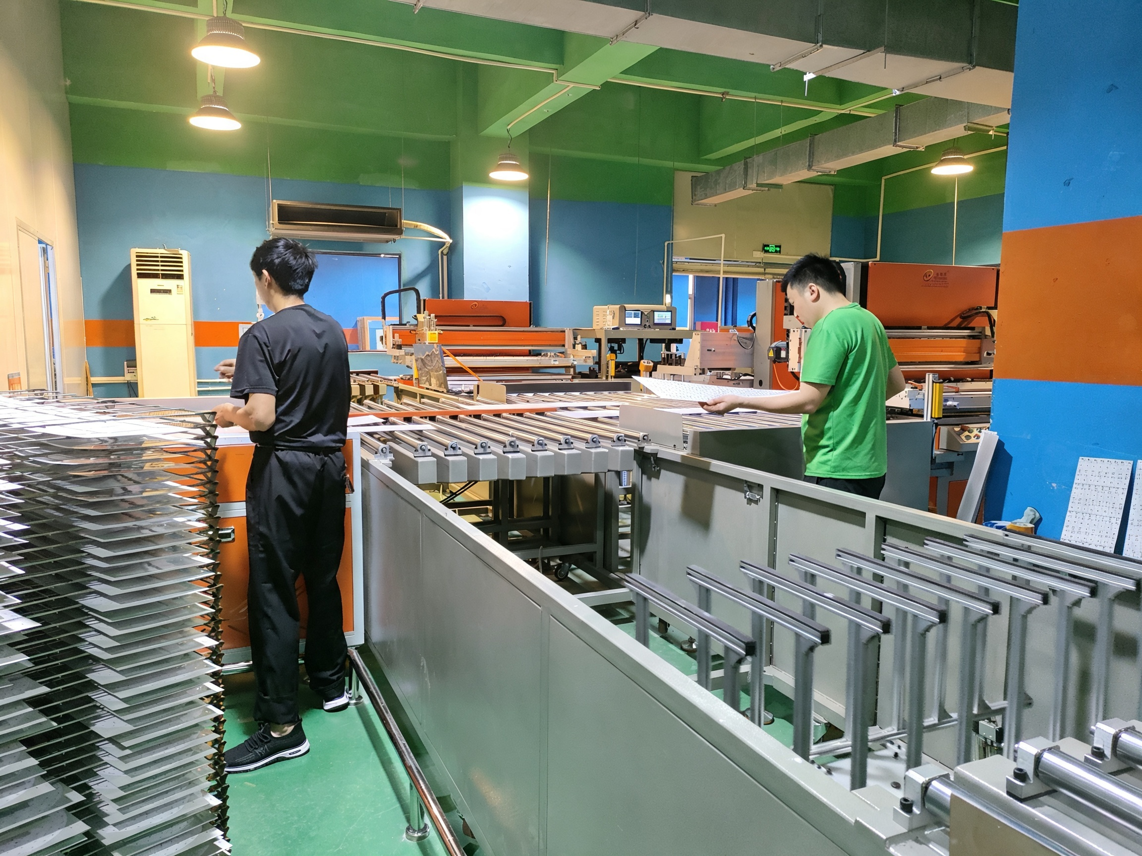 PCB manufacturing production line with workers handling circuit boards